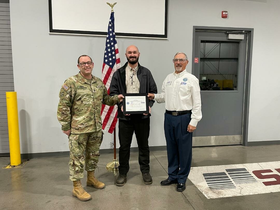 From left, SRC's Jeremy Owens and Adam Prier are recognized at a ceremony with retired Col. Steve Vanderhoof.